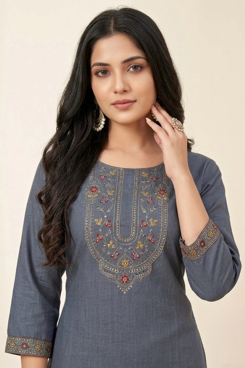 Woman wearing a blue embroidered traditional outfit on a beige background